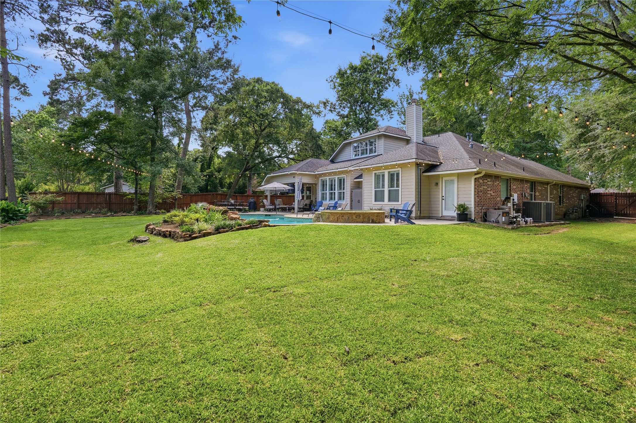 2408 Hollowbrook Lane Conroe, TX 77384 - Photo 41 of 49 This view allows you to appreciate the size of the back yard and the large space between you and neighbors. This is truly a gem!