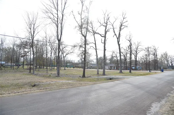 a view of tennis ground with trees in the background