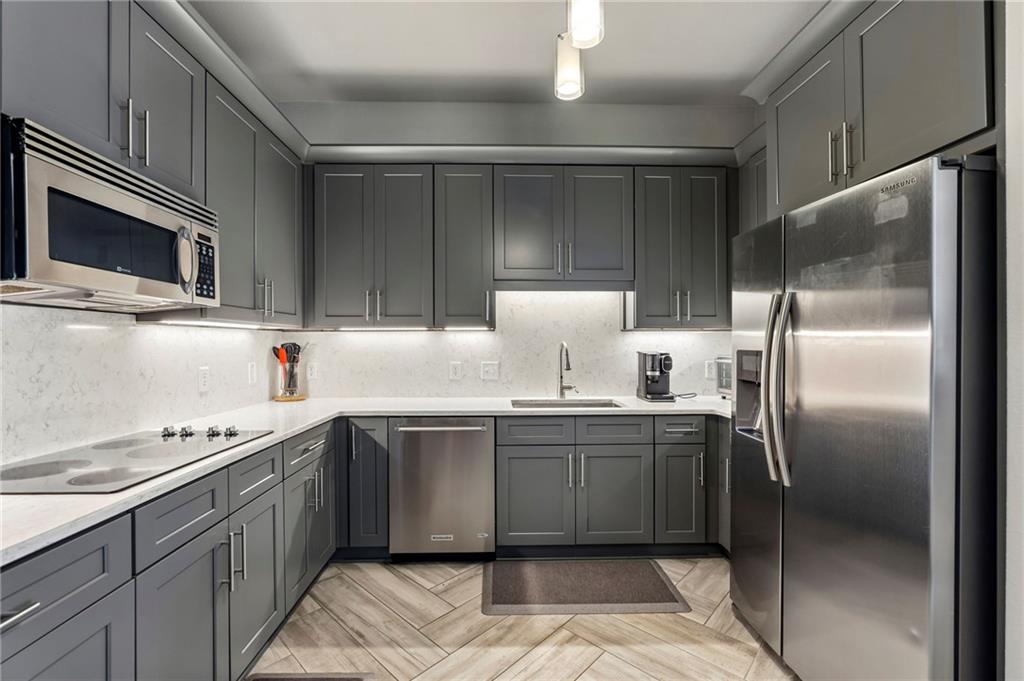 3445 Stratford Road Northeast, Unit 3105 Atlanta, GA 30326 - Photo 8 of 47 a kitchen with stainless steel appliances granite countertop a stove a sink and a refrigerator