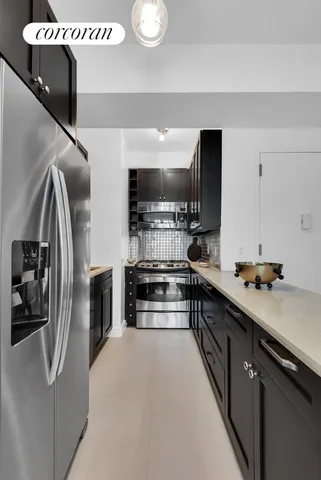 a kitchen with stainless steel appliances granite countertop a refrigerator and a stove