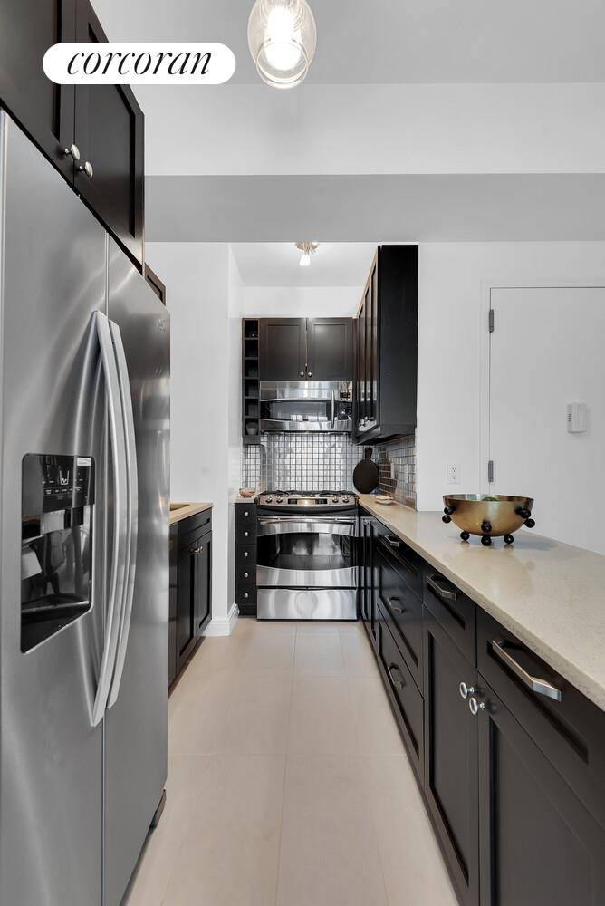 30-11 21st Street, Unit 5C Queens, NY 11102 - Photo 10 of 12 a kitchen with stainless steel appliances granite countertop a refrigerator and a stove