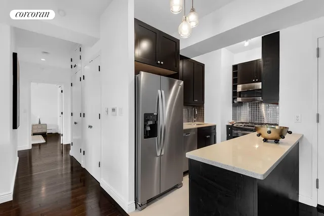 a kitchen with stainless steel appliances a refrigerator and a stove top oven