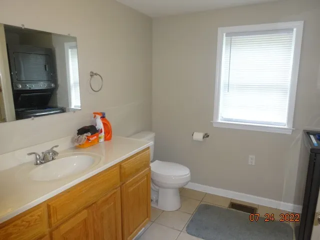 a bathroom with a sink toilet and a mirror