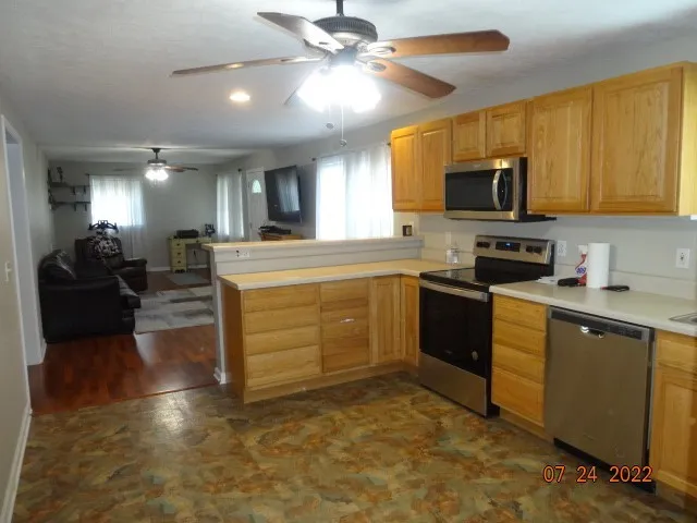 a kitchen with a stove a sink and a refrigerator