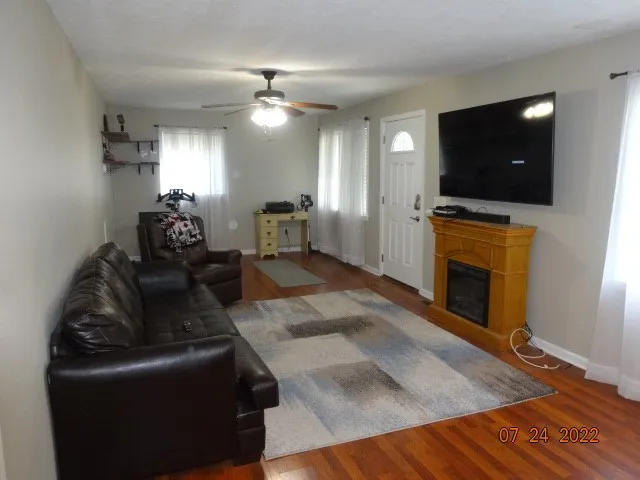 a living room with furniture and a flat screen tv