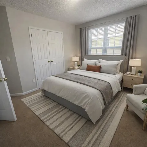 a bedroom with a bed and a window