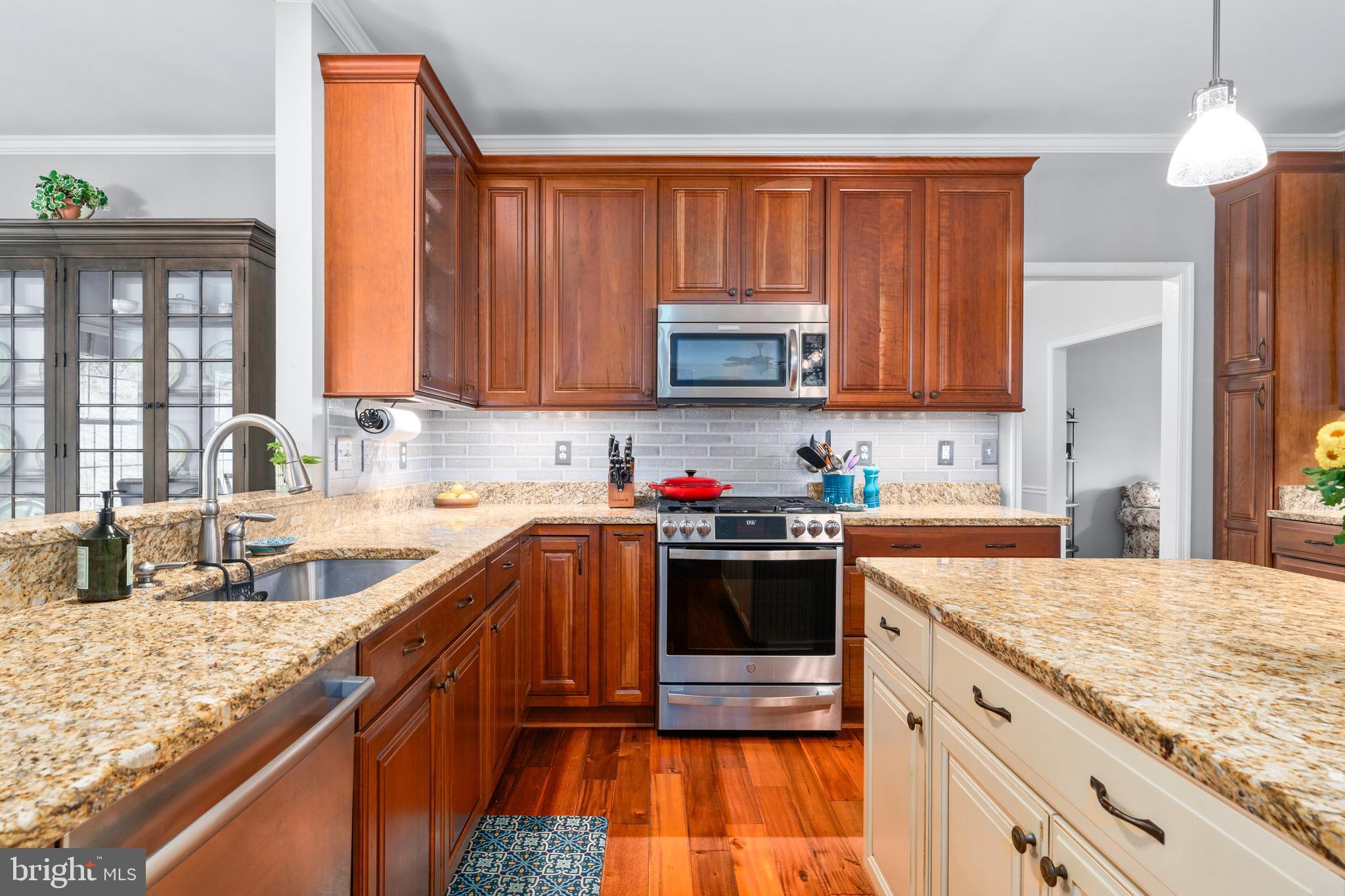 4644 Old Swimming Pool Road Braddock Heights, MD 21714 - Photo 11 of 60 a kitchen with stainless steel appliances granite countertop a stove a sink and a microwave