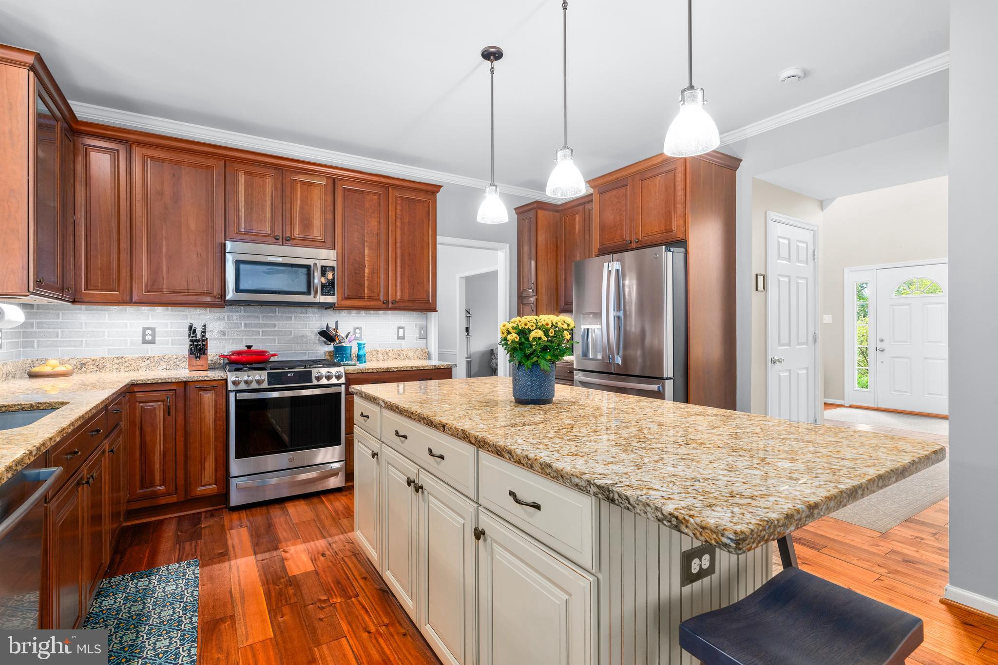 4644 Old Swimming Pool Road Braddock Heights, MD 21714 - Photo 12 of 60 a kitchen with stainless steel appliances granite countertop wooden cabinets a stove a sink and a wooden floors