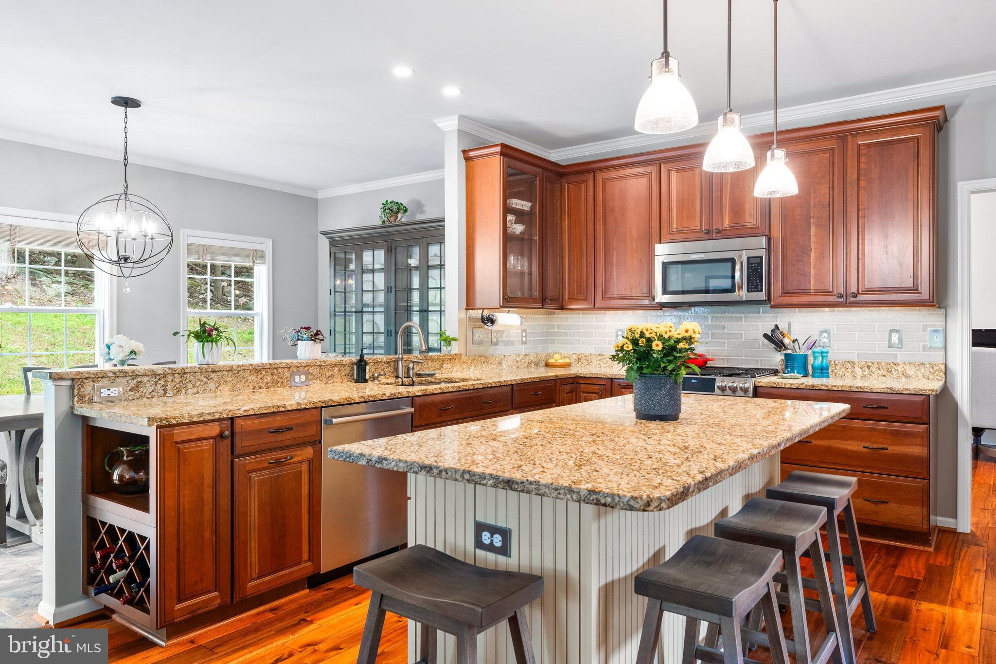 4644 Old Swimming Pool Road Braddock Heights, MD 21714 - Photo 10 of 60 a kitchen with granite countertop kitchen island granite countertop a stove a sink a dining table and chairs