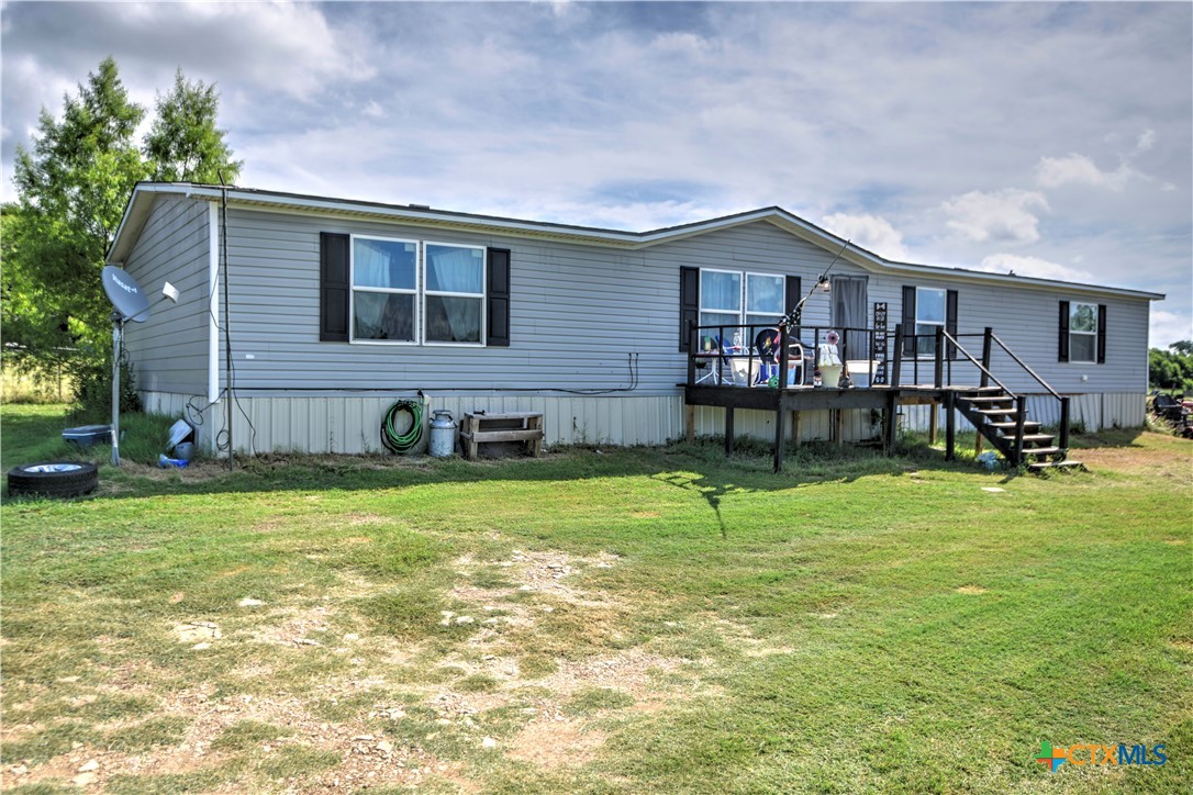 a backyard of a house with table and chairs