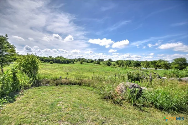 a view of a lake with a yard