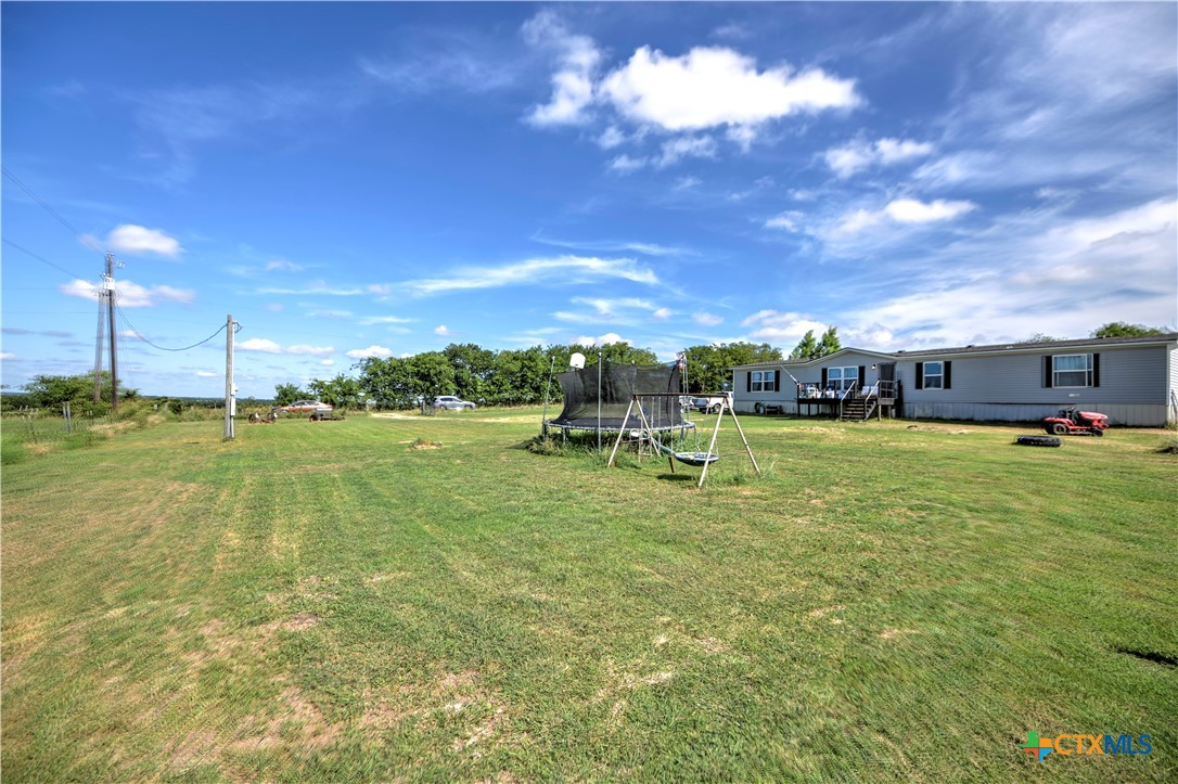 7085 Asa Road Temple, TX 76504 - Photo 8 of 16 a swimming pool with outdoor seating and yard