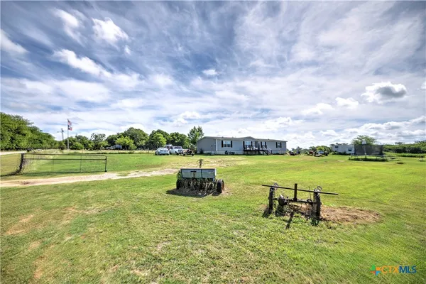 a view of a lake with couches in the outdoor space