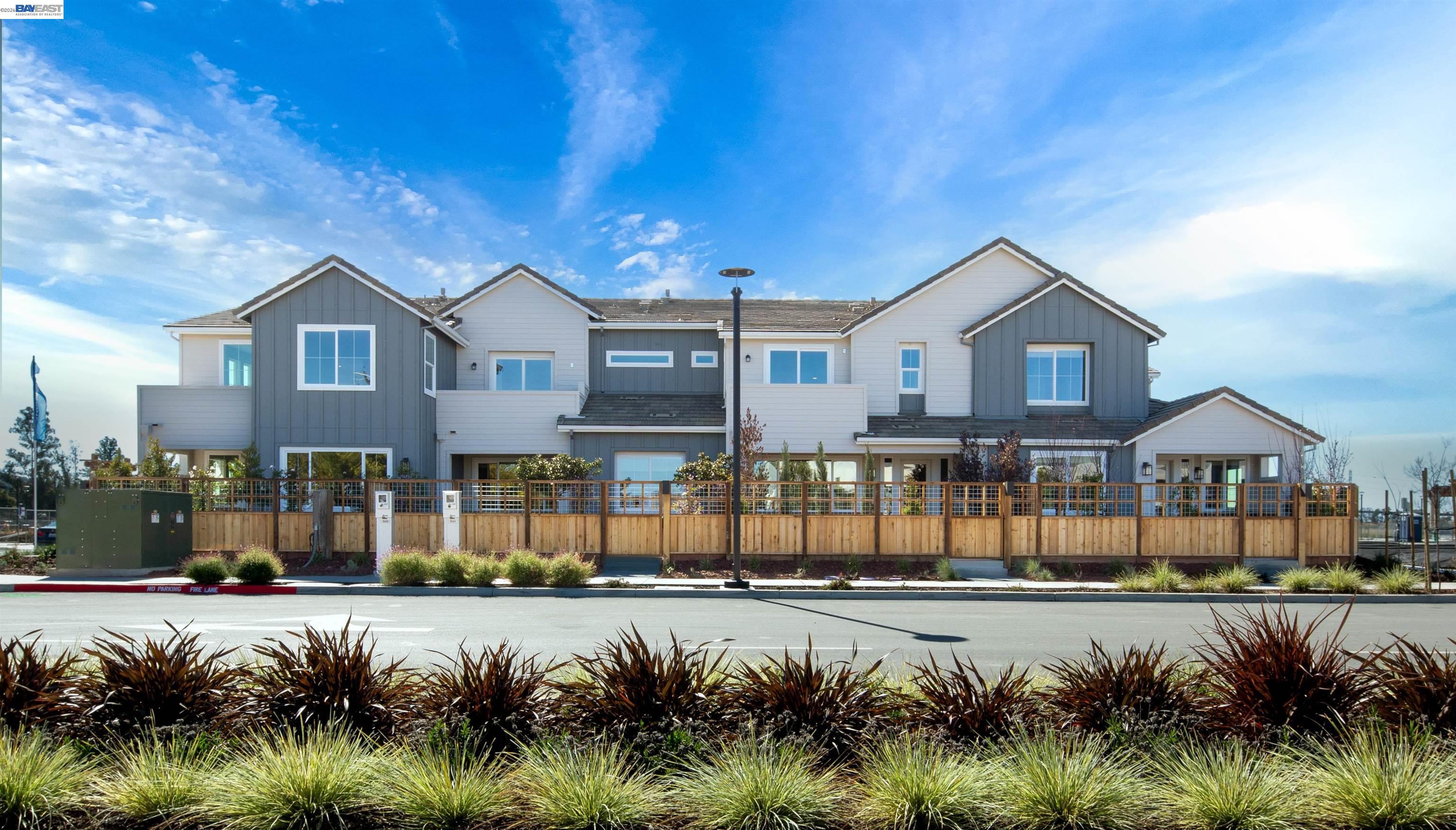 a front view of a house with a yard outdoor seating and mountain view