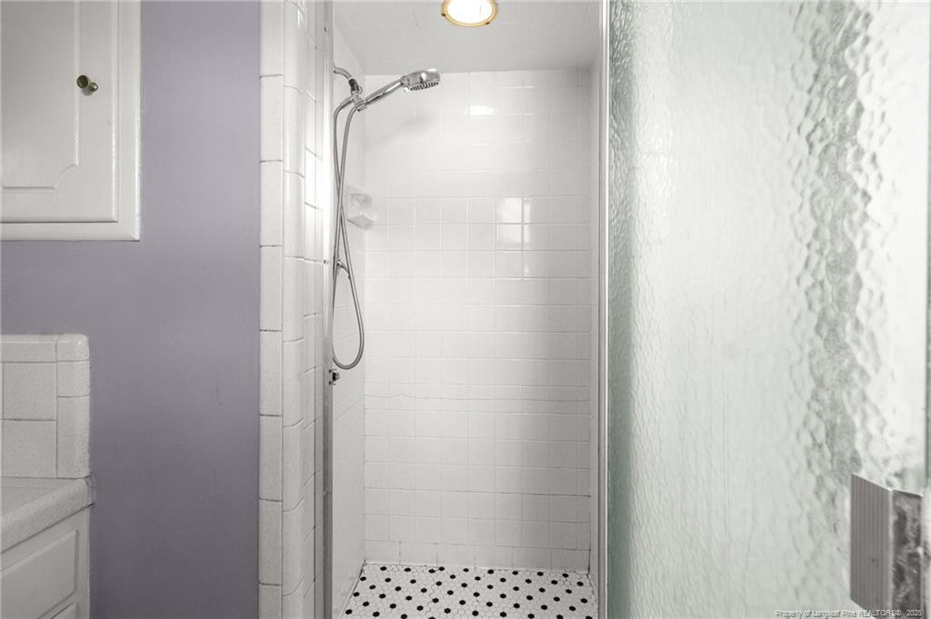 161 Summerhill Road Fayetteville, NC 28303 - Photo 11 of 36 a bathroom with a glass shower door