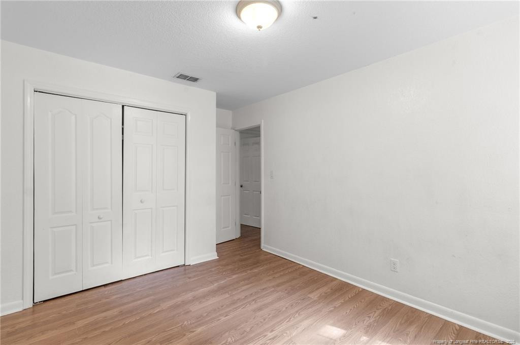 161 Summerhill Road Fayetteville, NC 28303 - Photo 13 of 36 a view of an empty room with wooden floor