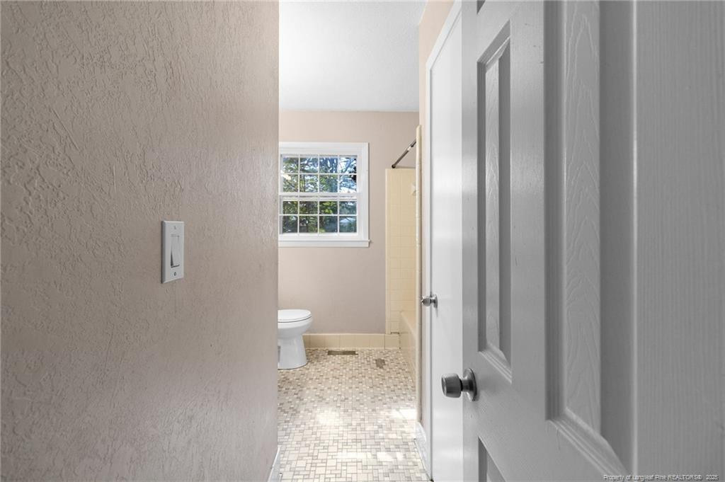 161 Summerhill Road Fayetteville, NC 28303 - Photo 14 of 36 a bathroom with a toilet and a shower