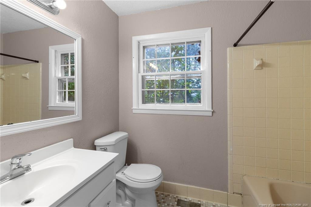 161 Summerhill Road Fayetteville, NC 28303 - Photo 15 of 36 a bathroom with a sink toilet and a mirror