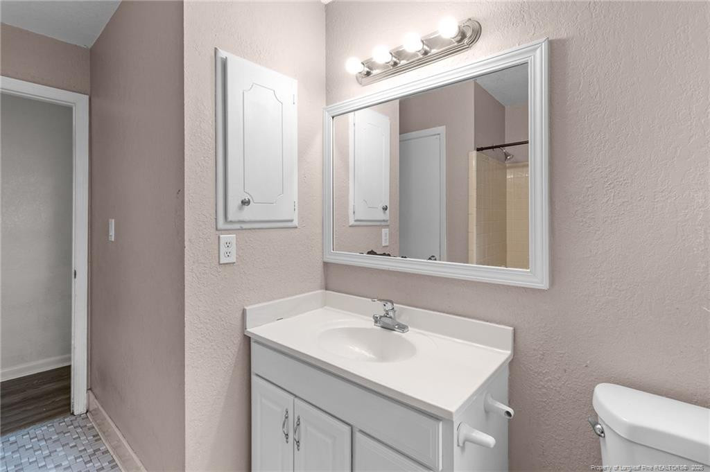 161 Summerhill Road Fayetteville, NC 28303 - Photo 16 of 36 a bathroom with a sink vanity and mirror