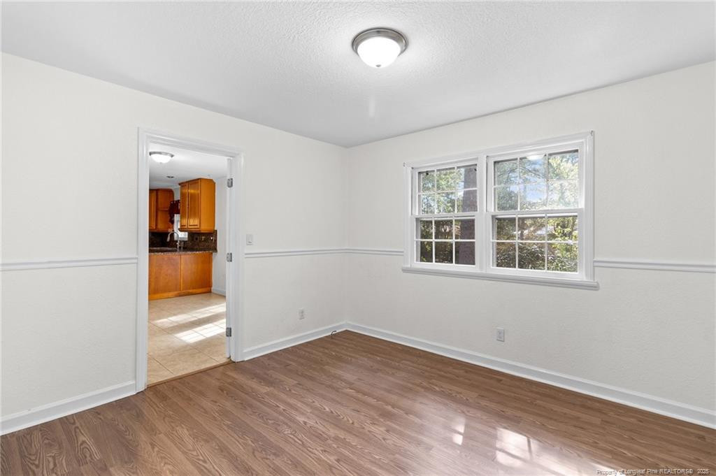 161 Summerhill Road Fayetteville, NC 28303 - Photo 21 of 36 an empty room with wooden floor and windows