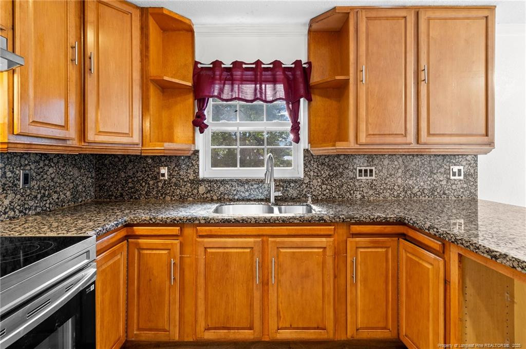 161 Summerhill Road Fayetteville, NC 28303 - Photo 25 of 36 a kitchen with granite countertop cabinets and window