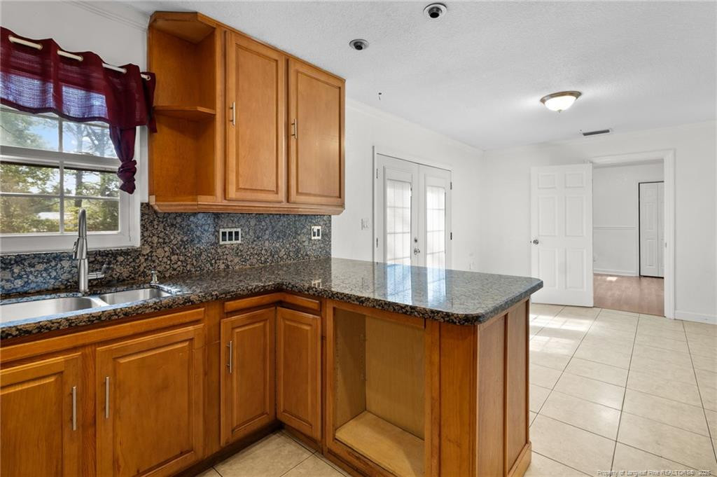 161 Summerhill Road Fayetteville, NC 28303 - Photo 26 of 36 a kitchen with stainless steel appliances granite countertop a sink and cabinets