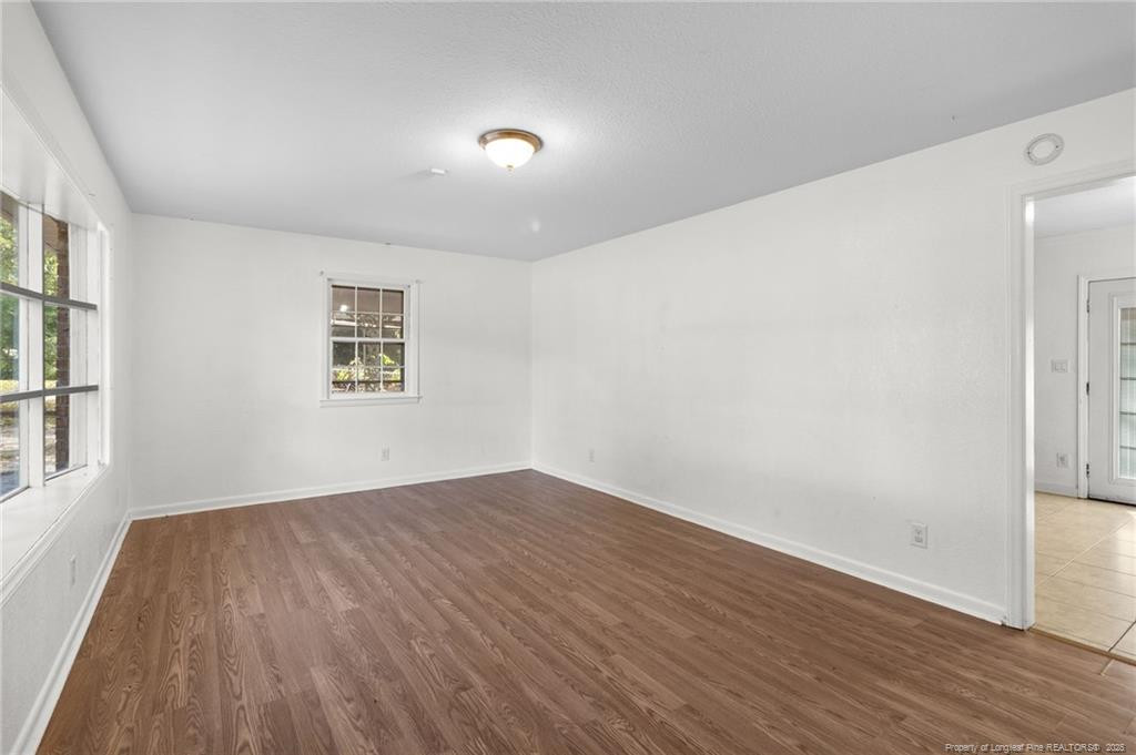 161 Summerhill Road Fayetteville, NC 28303 - Photo 30 of 36 an empty room with wooden floor and windows