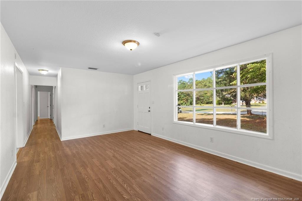 161 Summerhill Road Fayetteville, NC 28303 - Photo 31 of 36 a view of a big room with wooden floor and windows