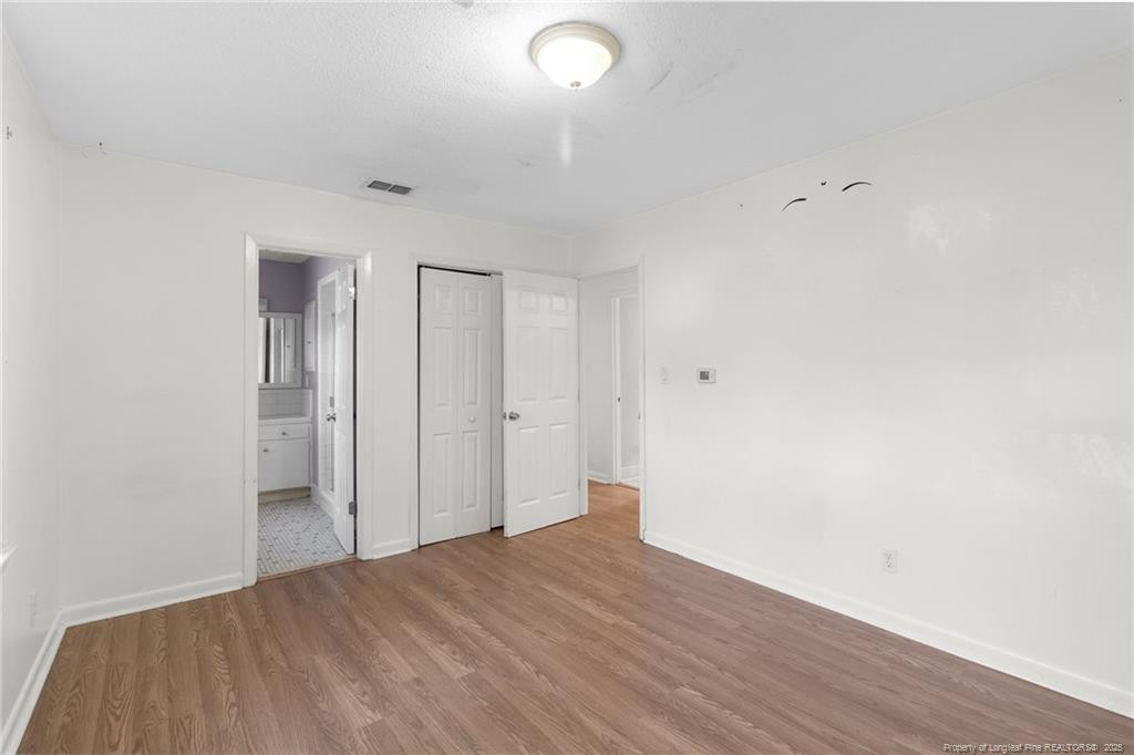 161 Summerhill Road Fayetteville, NC 28303 - Photo 8 of 36 a view of a room with wooden floor and white walls