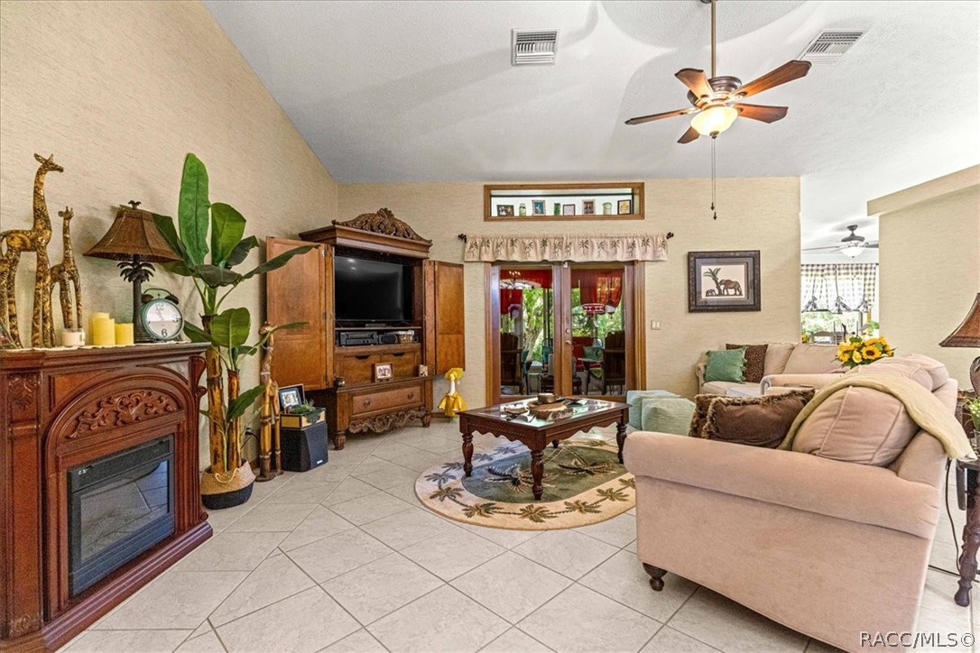 2964 South Cygnet Terrace Inverness, FL 34450 - Photo 4 of 67 a living room with furniture a chandelier and a fireplace