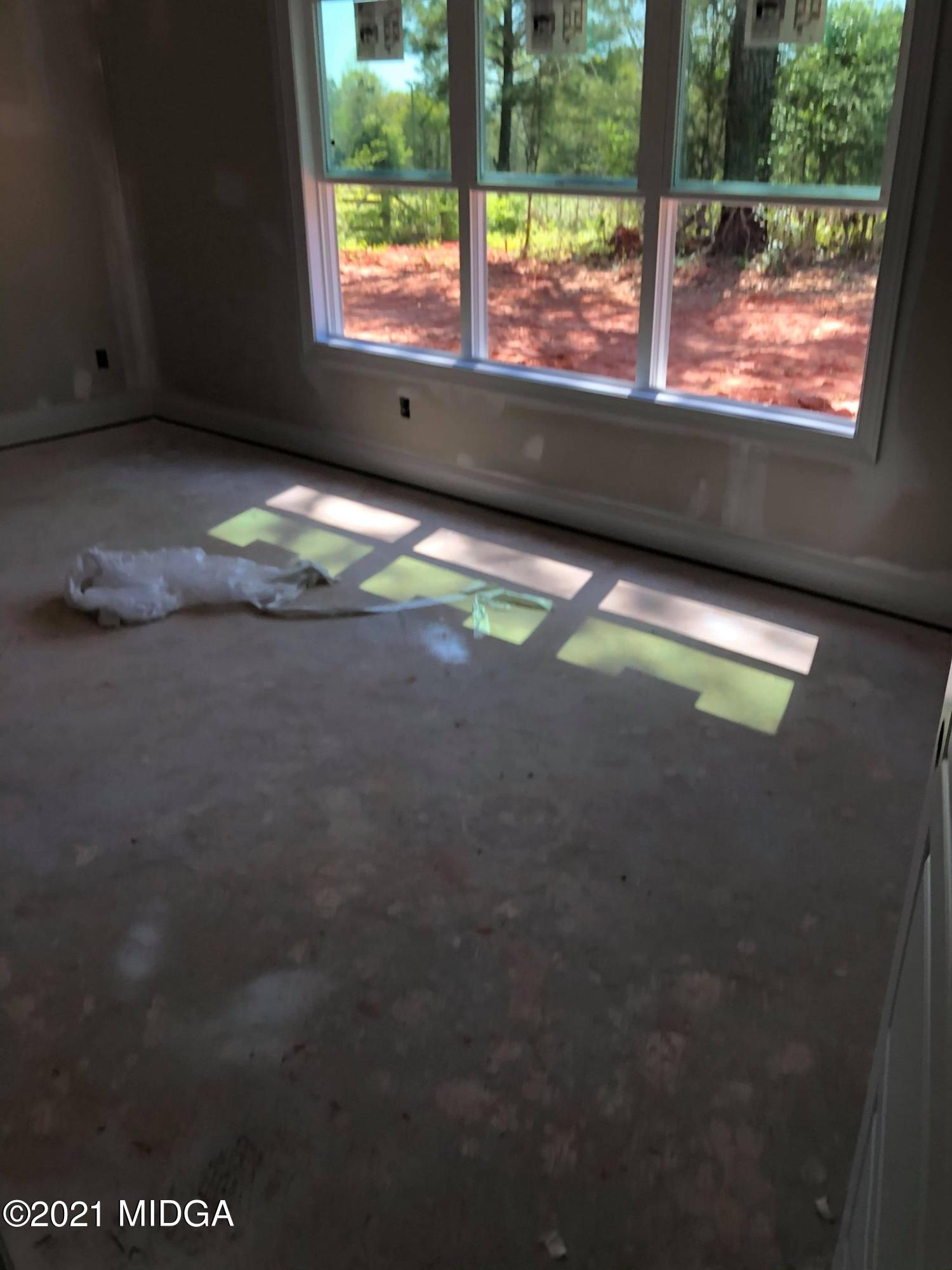 948 Chappell Mill Road Milner, GA 30257 - Photo 4 of 5 a view of an empty room with a window