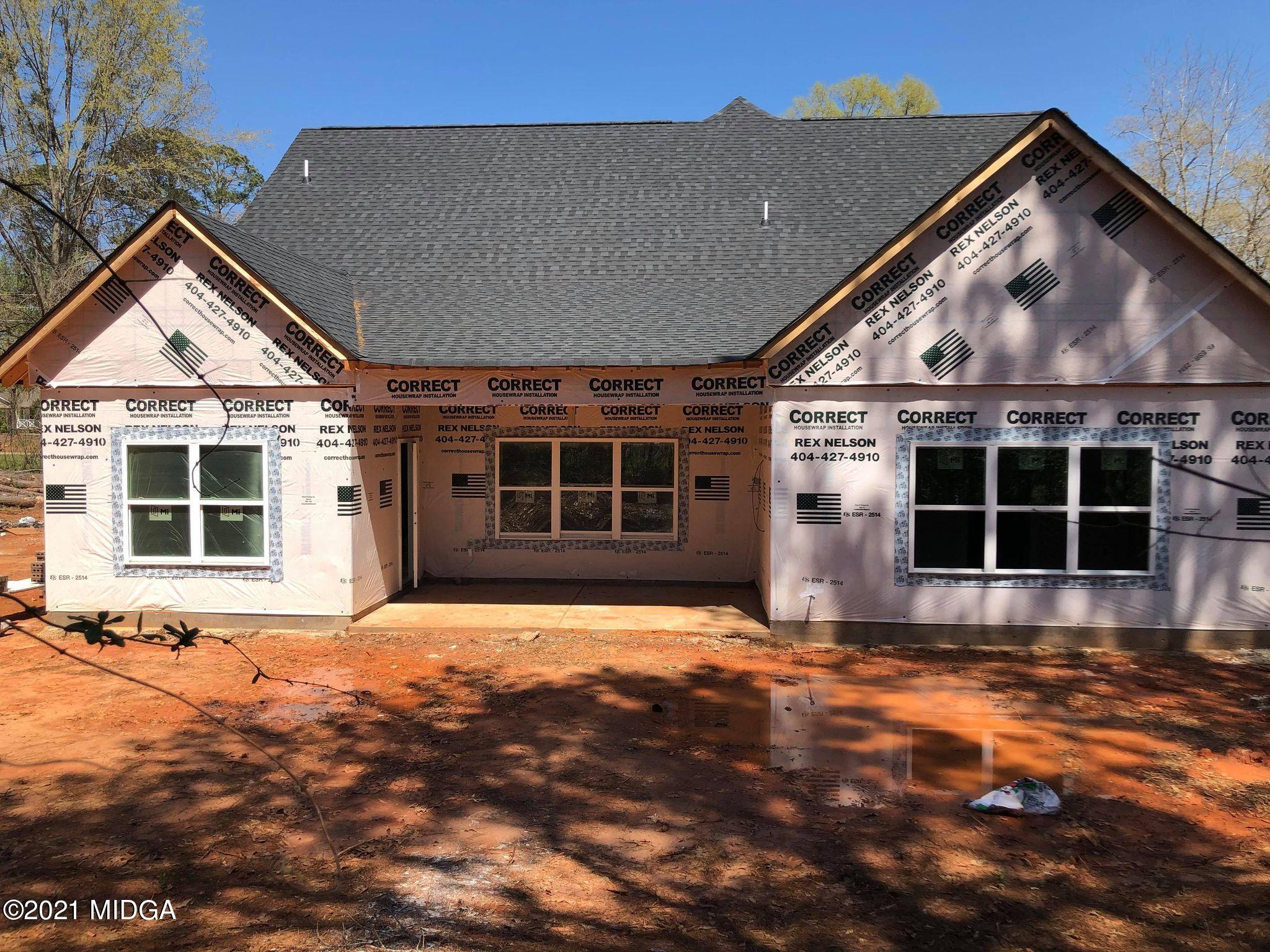 948 Chappell Mill Road Milner, GA 30257 - Photo 5 of 5 a view of a house with a floor to ceiling window next to a yard