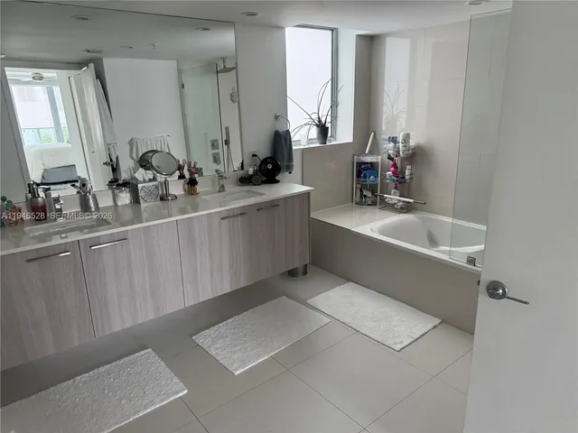 a bathroom with a double vanity sink and mirror
