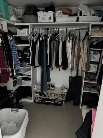 a room with gym equipment and clothes