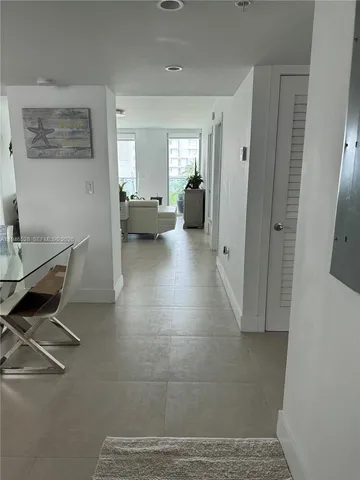 a living room with furniture and a mirror