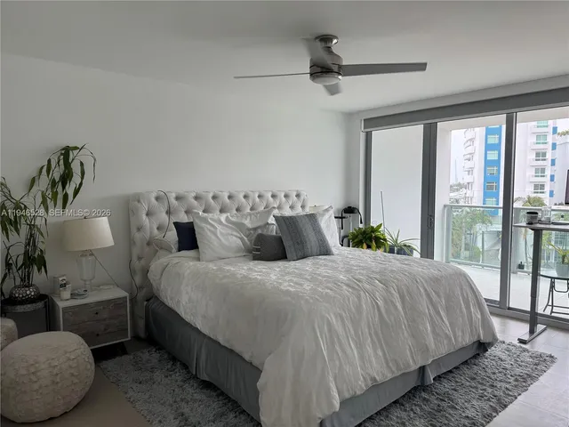 a bedroom with bed couch and window