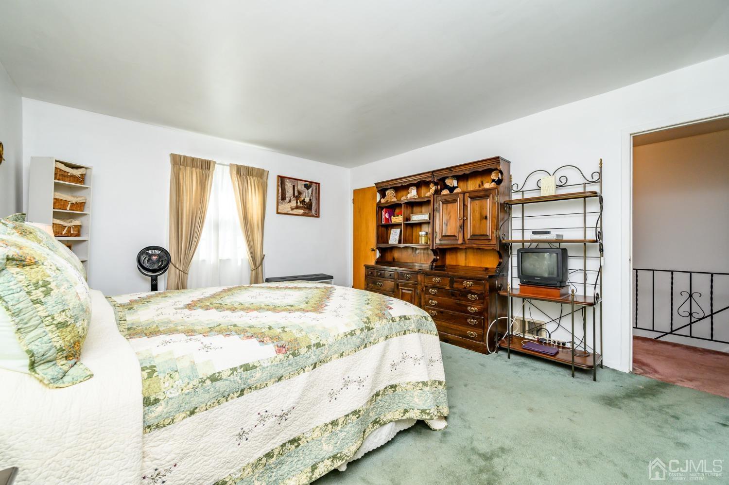 334 High Street Perth Amboy, NJ 08861 - Photo 16 of 33 a bedroom with a bed and a flat tv screen on the dresser