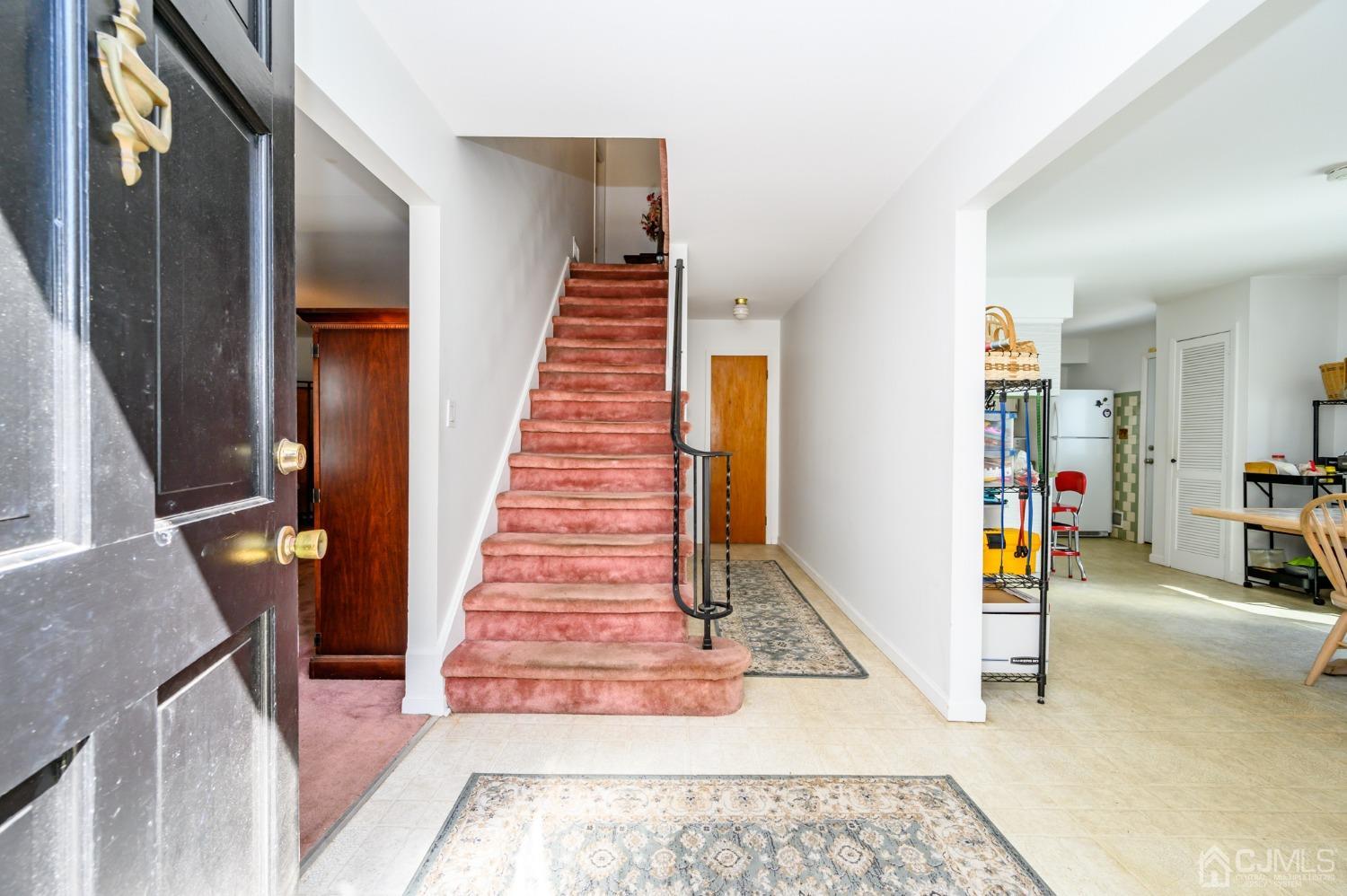 334 High Street Perth Amboy, NJ 08861 - Photo 4 of 33 a view of a livingroom with wooden floor and stairs