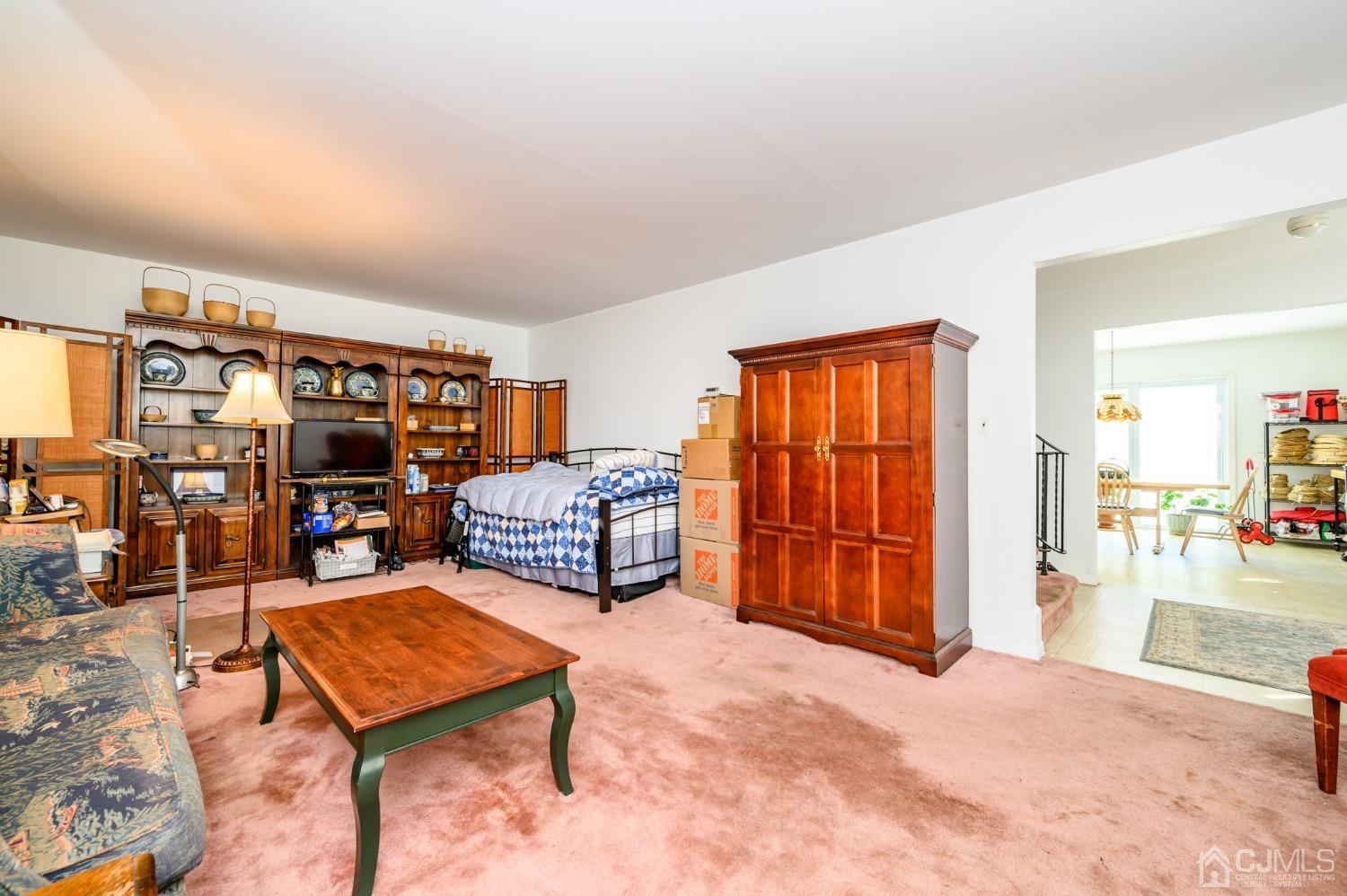 334 High Street Perth Amboy, NJ 08861 - Photo 6 of 33 a living room with furniture a couch and bookshelf