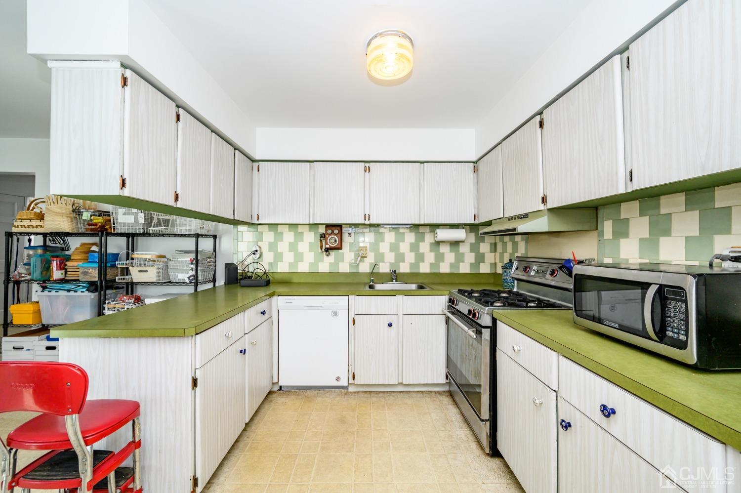 334 High Street Perth Amboy, NJ 08861 - Photo 9 of 33 a kitchen with stainless steel appliances granite countertop a stove and cabinets