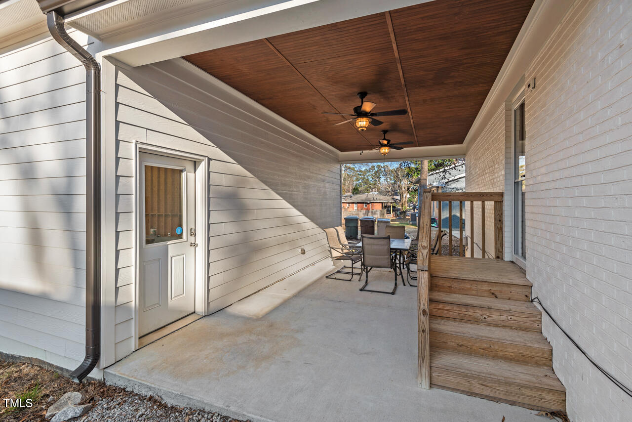 4908 Winterlochen Road Raleigh, NC 27603 - Photo 36 of 41 a view of a patio with table and chairs with wooden floor