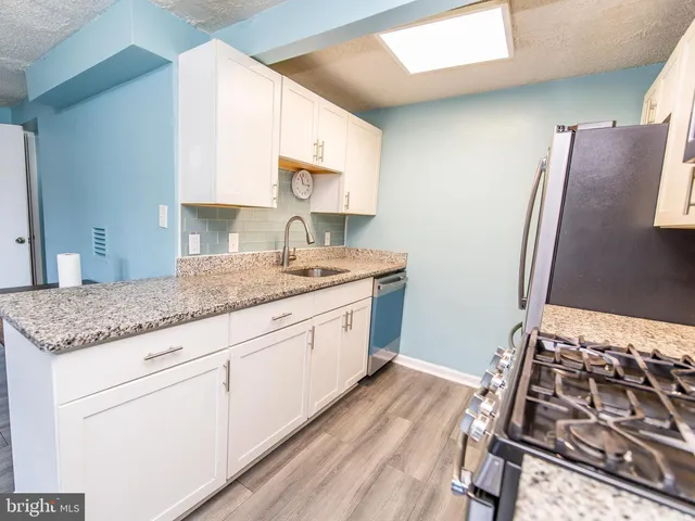 a kitchen with metallic refrigerator and stove