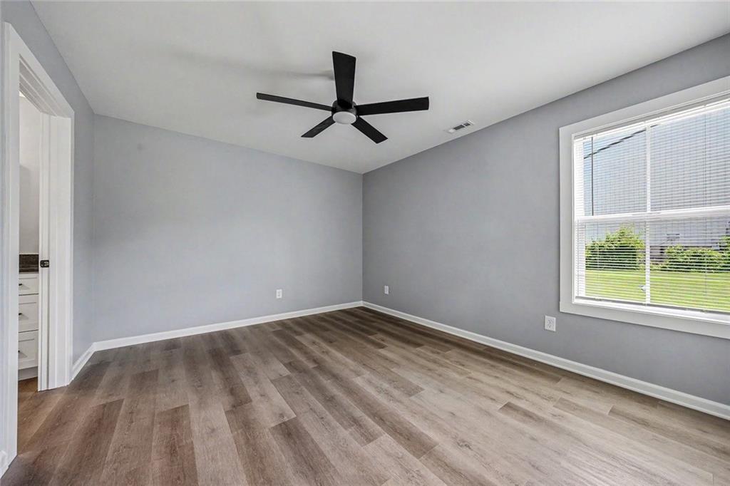 411 Hardy Avenue Southwest Rome, GA 30161 - Photo 14 of 27 wooden floor in an empty room with a window