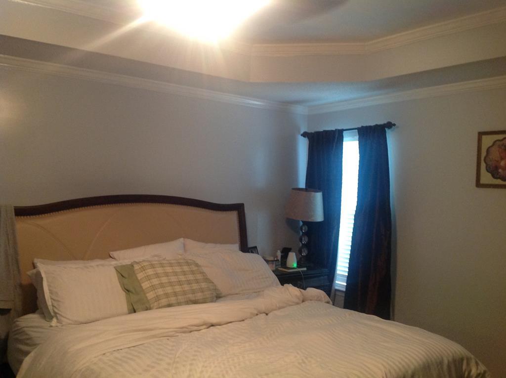 356 Elam Church Road Gray, GA 31032 - Photo 12 of 28 a bedroom with a bed and a lamp