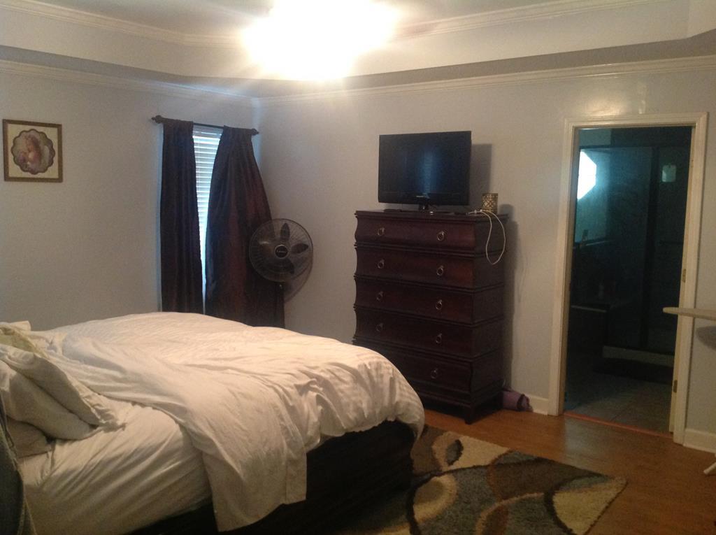 356 Elam Church Road Gray, GA 31032 - Photo 13 of 28 a bedroom with a bed and a flat screen tv
