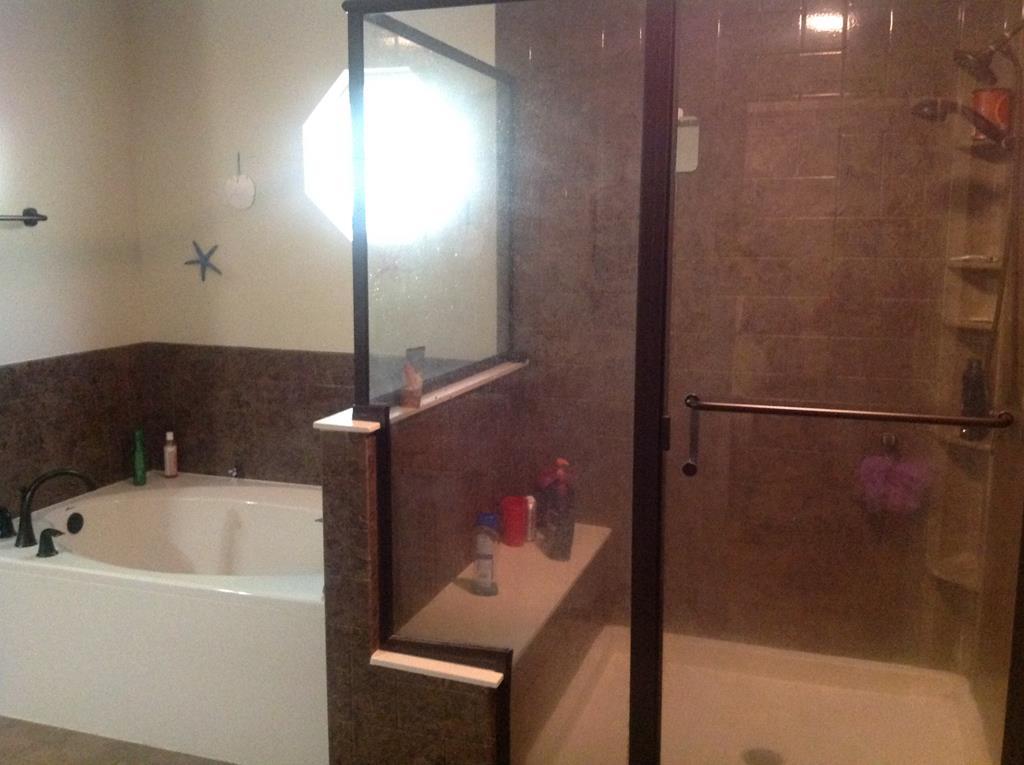 356 Elam Church Road Gray, GA 31032 - Photo 16 of 28 a bathroom with a bathtub and a shower