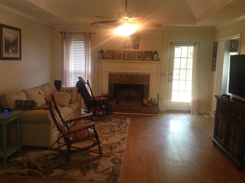 356 Elam Church Road Gray, GA 31032 - Photo 3 of 28 a living room with furniture a flat screen tv and a fireplace