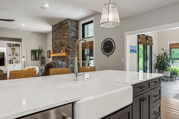 a bathroom with a granite countertop sink and a toilet