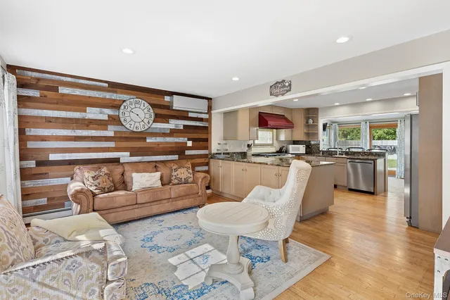 a living room with furniture and kitchen view