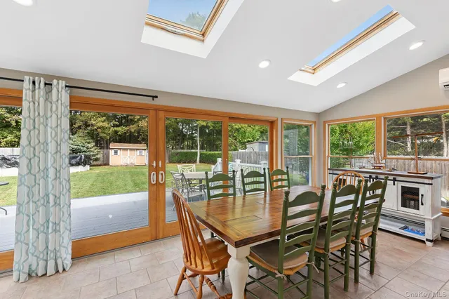 a dining room with furniture and wooden floor